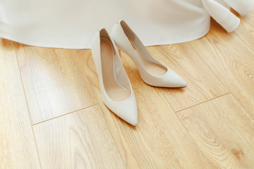 White shoes for the bride on a wooden background