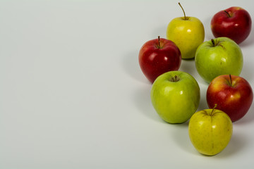 Apples red, green and yellow on a white background.