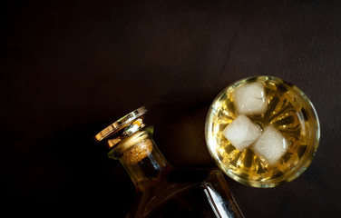 whiskey bottle and whiskey glass on concrete background,Top view with copy space for your text