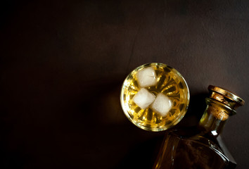 whiskey bottle and whiskey glass on concrete background,Top view with copy space for your text