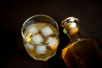 Fototapeta na wymiar whiskey bottle and whiskey glass on concrete background,Top view with copy space for your text
