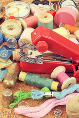 Fototapeta na wymiar Retro portable sewing machine and sewing tools