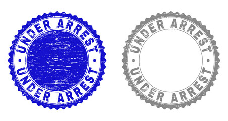 Grunge UNDER ARREST watermarks isolated on a white background. Rosette seals with grunge texture in blue and gray colors. Vector rubber stamp imprint of UNDER ARREST title inside round rosette.