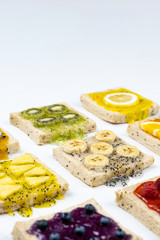 Delicious colourful minimal mix fruits jam on sliced bread. Set on white background.