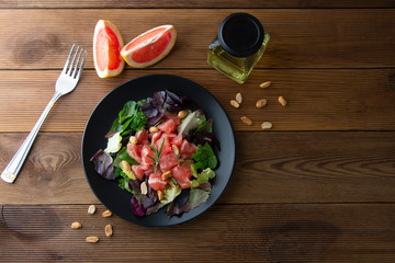 Healthy green salad with grapefruit, lose weigh food. Diet plan. Wooden rustic table. Copy space.