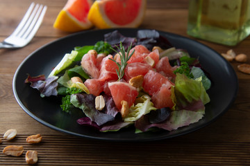 Healthy green salad with grapefruit, lose weigh food. Diet plan. Wooden rustic table.