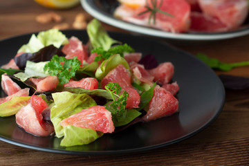 Healthy green salad with grapefruit, lose weigh food. Diet plan. Wooden rustic table.