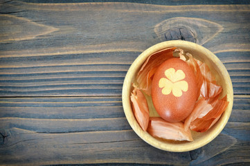 Easter egg colored naturally with onion peel, background with copy space