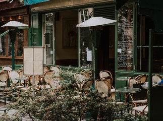 Cozy street with tables of cafe in Paris, France