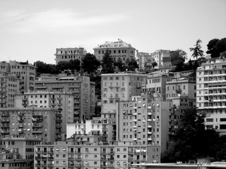 Genova, Italy - 01/24/2019: An amazing caption of the city of Genova from the hills in winter days, with a great grey sky, some natural river and beautiful buildings 