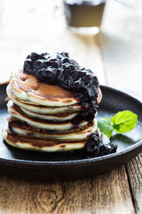 Stack of blueberry pancakes with homemede berry jam,  healthy breakfast