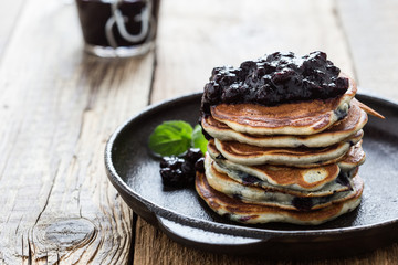 Stack of blueberry pancakes with homemede berry jam,  healthy breakfast
