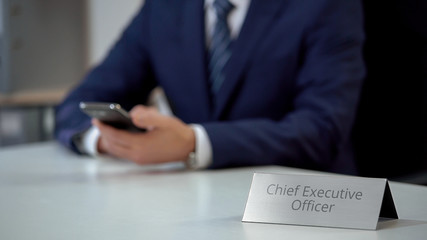 Fototapeta premium Company chief executive officer chatting with partners on smartphone, business