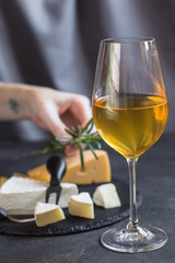 white wine in a transparent glass and snack. food background. top photo