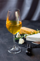 white wine in a transparent glass and snack. food background. top photo