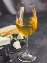 white wine in a transparent glass and snack. food background. top photo