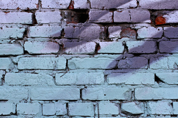 Colourful (blue and grey) brick wall with hole as background, texture