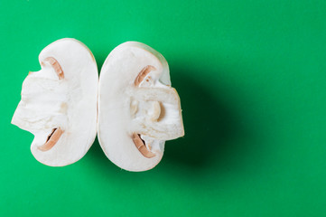Sliced champignon on the green background. Food for vegan.