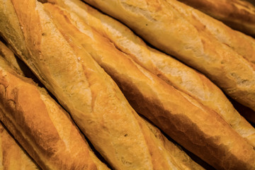 Fresh pastries from supermarket. White bread, roll, baguette. Tasty and healthy food. Texture and background.