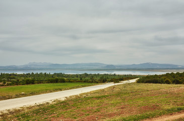 landscape with oranges and pomegranate garden and mountains.