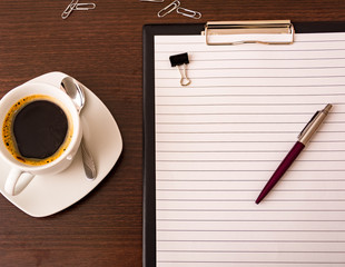holder for paper with a red pen on a wooden table in the office with a red stamp