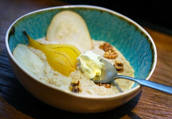 Oatmeal with pear and walnuts on almond milk
