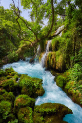 Naklejka na ściany i meble beautiful limestone waterfall forest