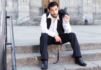 Thoughtful man sitting on steps