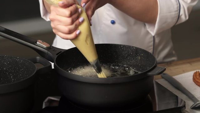 Cooking churos, dough churos on the pan.