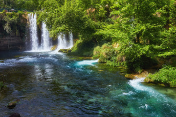 Fototapeta na wymiar The scenic lush green park surrounds the gorge with Upper Duden Waterfall, the popular tourist place, Antalya, Turkey.
