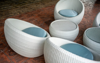 Above view of Woven wicker seamless pattern table and chairs on orange floor.