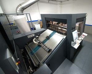 Press printing - Offset machine. Printing technique where the inked image is transferred from a plate to a rubber blanket, then to the printing surface.