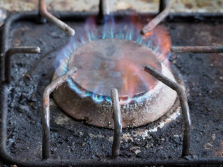 dirty gas stove. burning fire.