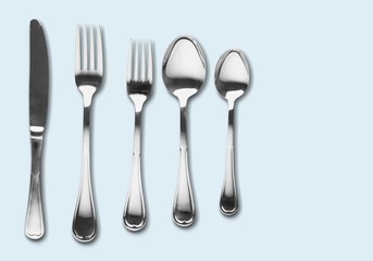 Fork, spoon and knife on blue background