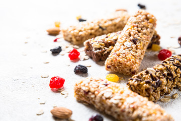 Granola bar with nuts, fruit and berries on white.