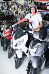 young  purchaser sitting on the motorbike  with helmet