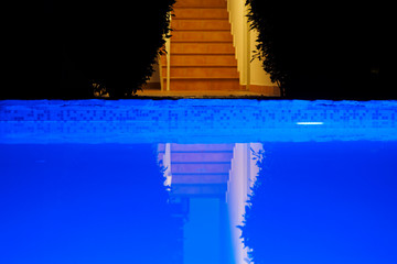 outdoor swimming pool at night.