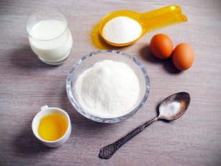Fototapeta na wymiar Ingredients for baking - eggs, flour, wheat. Kitchen utensils. Holiday Baking, Flour Dough.