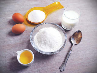 Fototapeta na wymiar Ingredients for baking - eggs, flour, wheat. Kitchen utensils. Holiday Baking, Flour Dough.