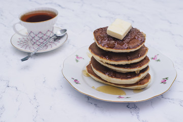 Pancake folded stack of with liquid honey on wooden background.selective focus.