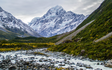 Fototapeta na wymiar Scenic landscape view of Hooker Valley, Aoraki/Mount Cook National Park, South Island of New Zealand. Snow covered mountains. Tourist (backpackers) popular hiking or walking attraction/destination.