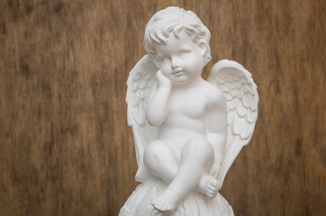 Beautiful white Angel on wooden background
