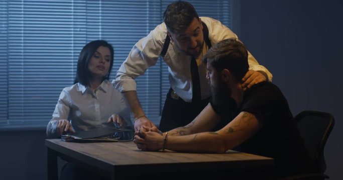 Violent policeman interrogating criminal about drugs