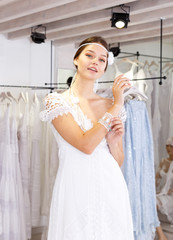 Obraz na płótnie Canvas Girl fitting wedding dress