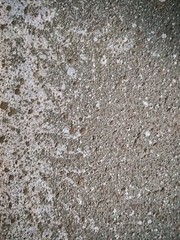 Texture drops and sprays of light brown paint on plaster