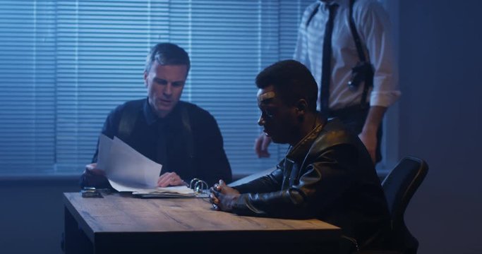 Police examining black man about drugs
