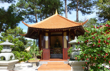 The Vietnamese pagoda is surrounded by beautiful trees and shrub