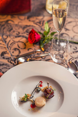 baked chicken wings with scallop and sauce served on white plate, romantic evening with delicios food on valentines day 