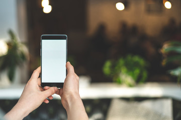 Woman hand with cellular against blurred background