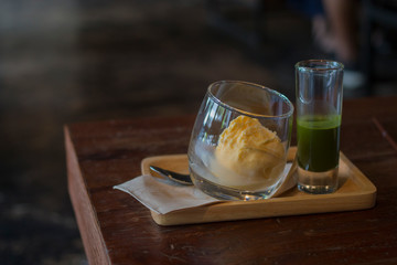 Delicious green tea Affogato serve on wood plate.